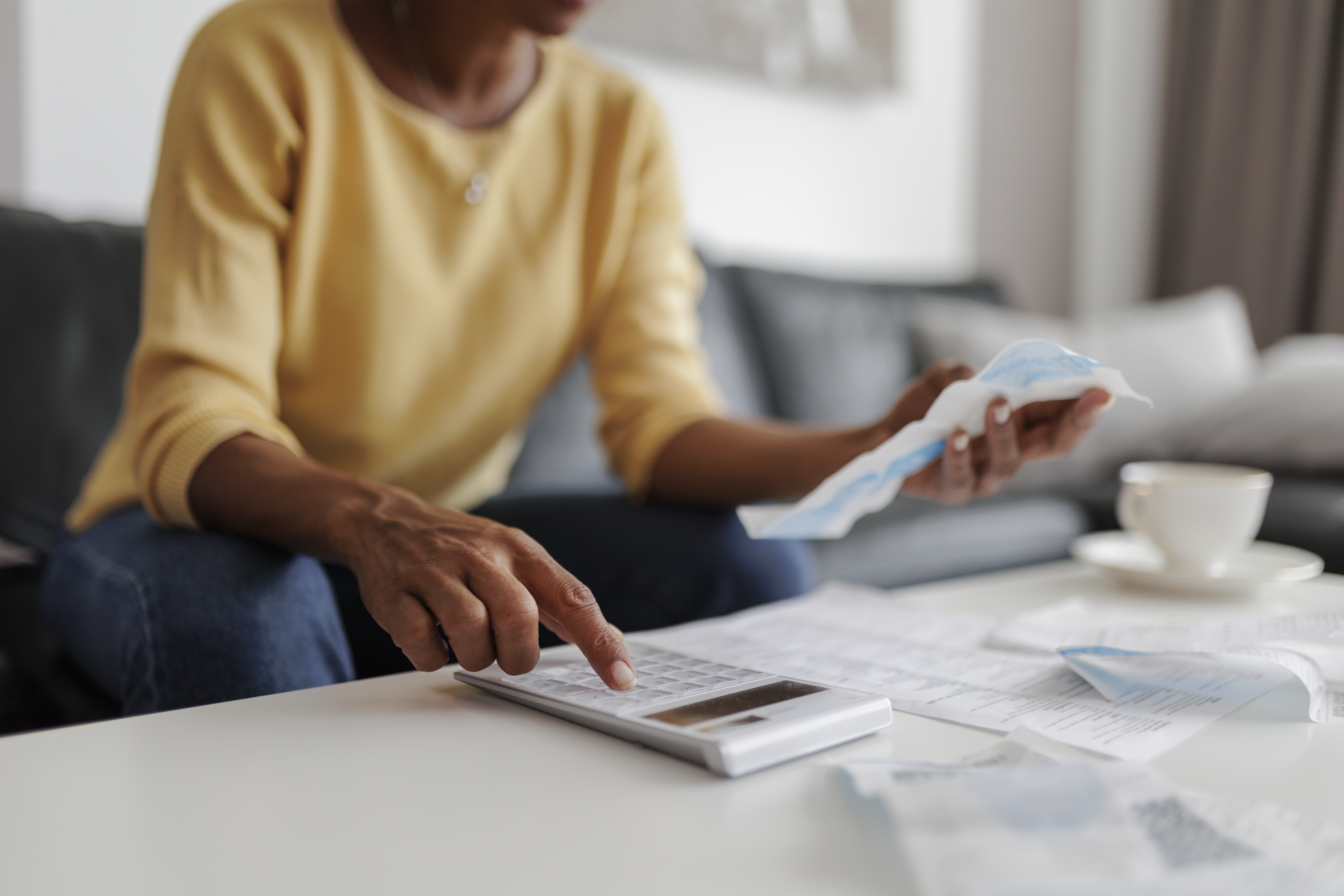 close up photo of a woman checking energy payments at home for cost-of-living crisis payments